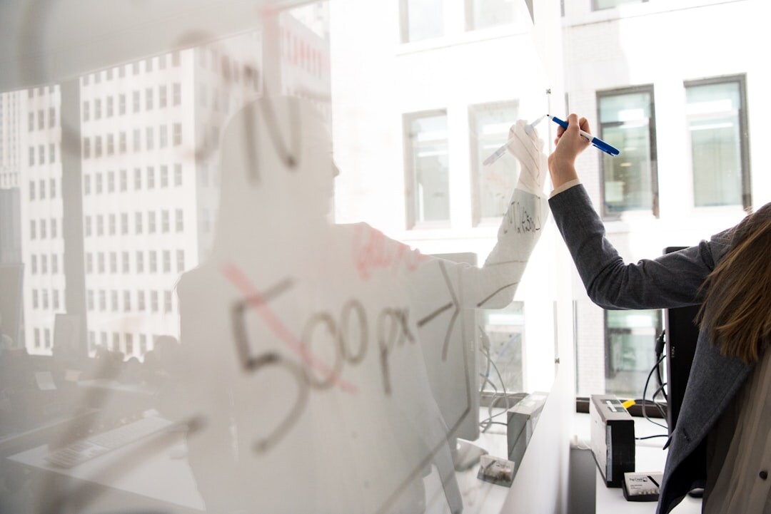 Team of consultants planning a business growth strategy on a whiteboard